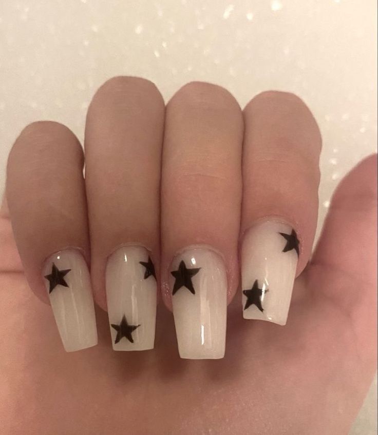 Soft White Nails with Black Star Designs